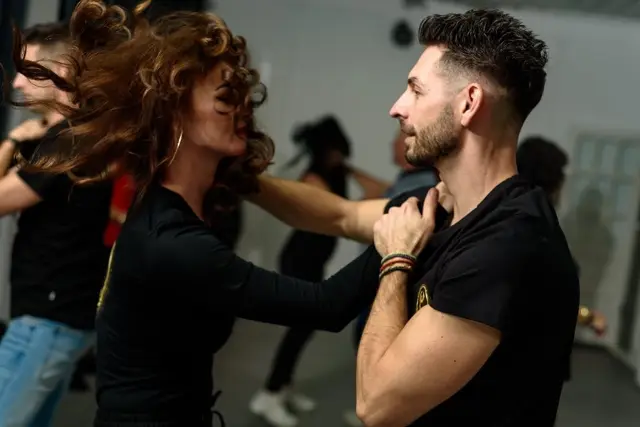 Cursanți dansând salsa în sala Magic Dance Studio